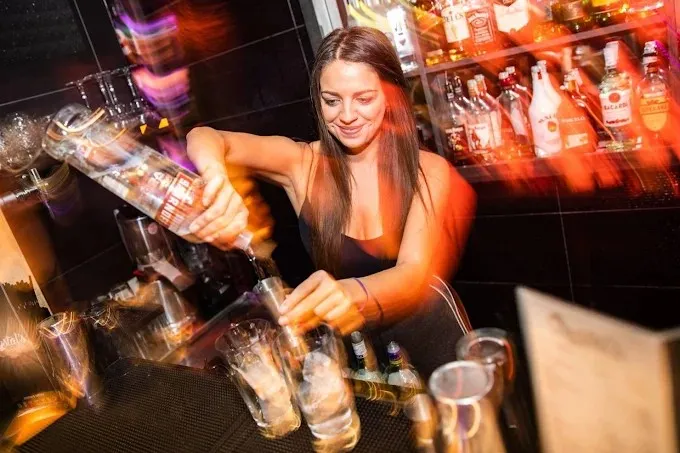 A bartender pouring drinks at Crystal’s